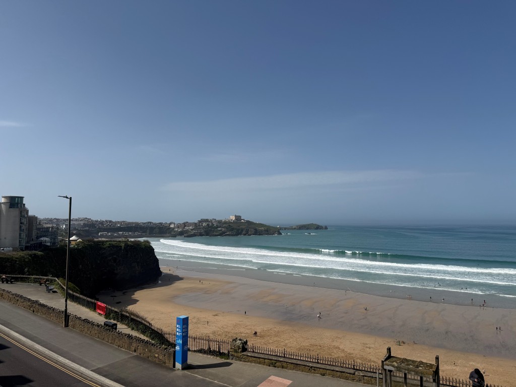 Lot: 132 - SPACIOUS TWO-BEDROOM APARTMENT WITH STUNNING SEA VIEWS AND PARKING - View from balcony over Tolcarne beach and towards town centre